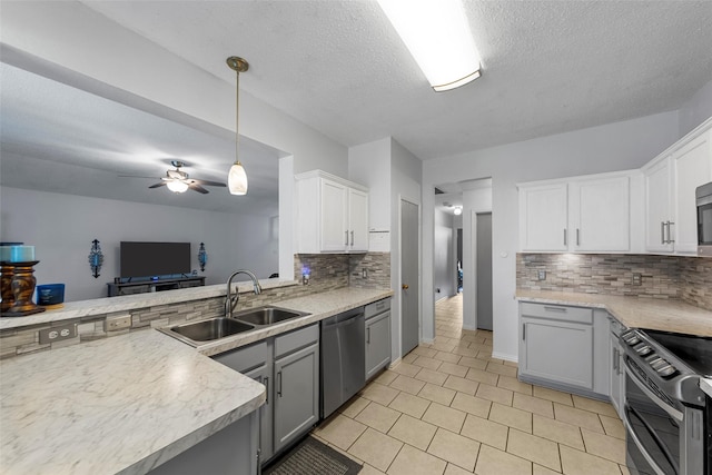 2312 Collier Dr, Mckinney, TX 75071 - kitchen with stainless steel appliances, a sink, tasteful backsplash, light countertops, and white cabinetry