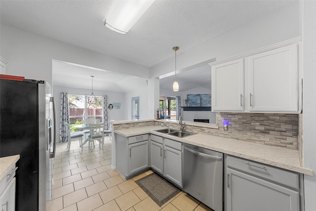 2312 Collier Dr, Mckinney, TX 75071 - kitchen with appliances with stainless steel finishes, a sink, gray cabinetry, light tile patterned flooring, and a textured ceiling