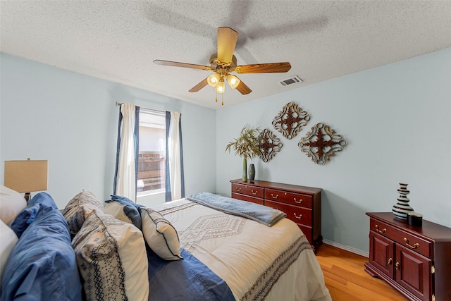 2312 Collier Dr, Mckinney, TX 75071 - bedroom featuring light wood-style floors, ceiling fan, baseboards, and a textured ceiling