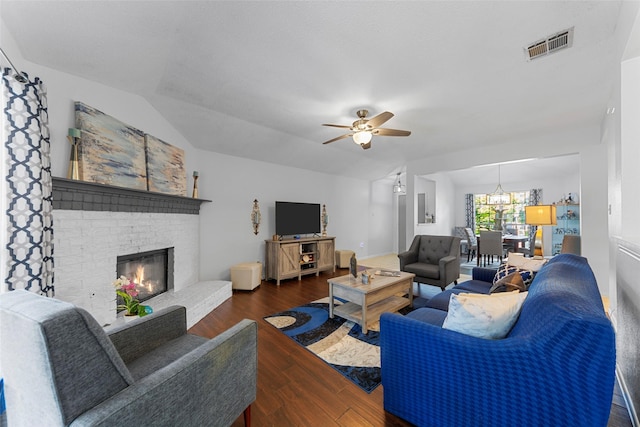 2312 Collier Dr, Mckinney, TX 75071 - living room featuring ceiling fan, wood finished floors, a brick fireplace, and a chandelier