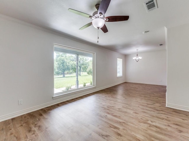 614 Shady Ln, Seagoville, TX 75159 - spare room with a chandelier, ornamental molding, baseboards, light wood-style floors, and ceiling fan