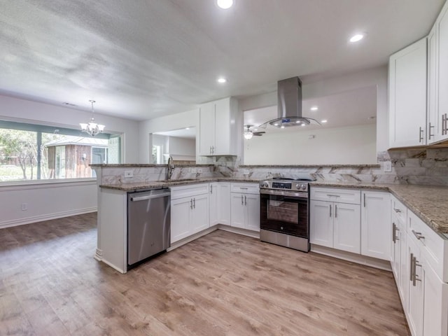 614 Shady Ln, Seagoville, TX 75159 - kitchen with stainless steel appliances, island exhaust hood, a sink, white cabinets, and a chandelier