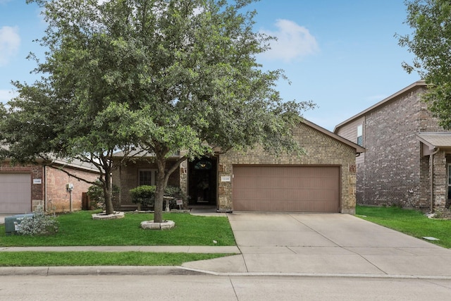 1336 Castlegar Ln, Fort Worth, TX 76247 - view of property hidden behind natural elements featuring a garage, a front lawn, concrete driveway, and brick siding