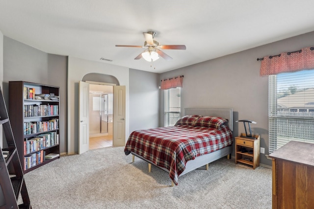1336 Castlegar Ln, Fort Worth, TX 76247 - carpeted bedroom with multiple windows, ensuite bathroom, ceiling fan, and baseboards