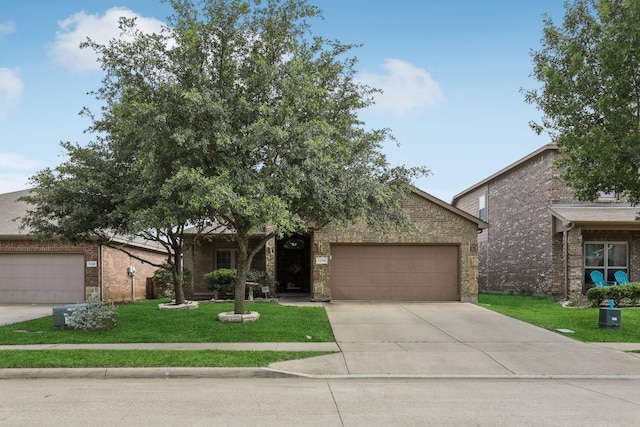 1336 Castlegar Ln, Fort Worth, TX 76247 - obstructed view of property featuring a garage, concrete driveway, a front yard, and brick siding