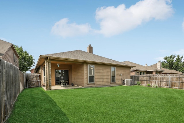 1336 Castlegar Ln, Fort Worth, TX 76247 - back of property featuring central AC unit, a patio, and a chimney