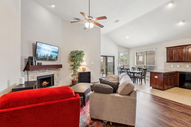 1336 Castlegar Ln, Fort Worth, TX 76247 - living room featuring a ceiling fan, high vaulted ceiling, a fireplace, recessed lighting, and light wood-type flooring