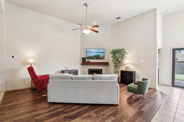 1336 Castlegar Ln, Fort Worth, TX 76247 - living room featuring wood finished floors, a fireplace, ceiling fan, high vaulted ceiling, and baseboards