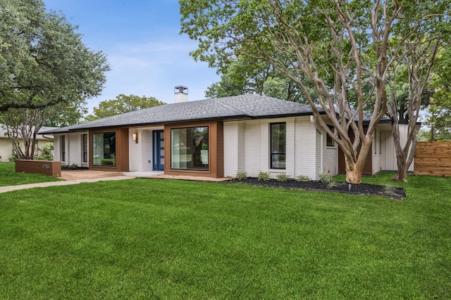 4216 Rickover Dr, Dallas, TX 75244 - view of front of house with brick siding, a shingled roof, and a chimney
