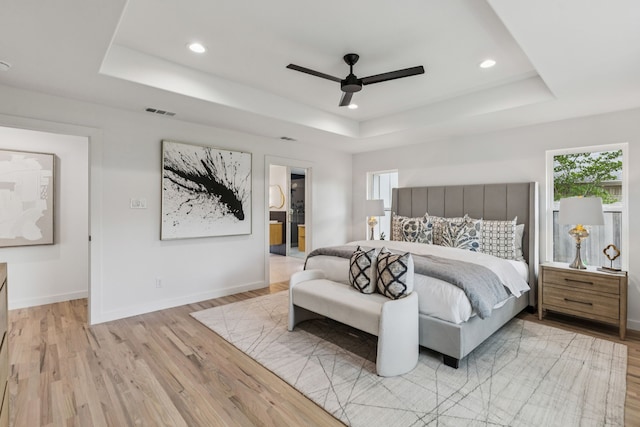 4216 Rickover Dr, Dallas, TX 75244 - bedroom featuring a tray ceiling, light wood-type flooring, multiple windows, and recessed lighting