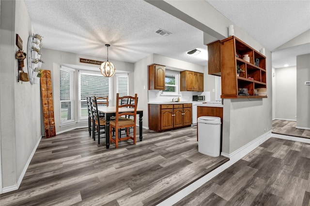 716 Vickie Dr, Azle, TX 76020 - kitchen featuring brown cabinetry, open shelves, a textured ceiling, a sink, and dark wood-type flooring