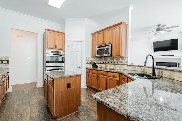 1005 Ruidoso Downs Dr, Talty, TX 75160 - kitchen with stainless steel microwave, stone counters, backsplash, crown molding, and a ceiling fan