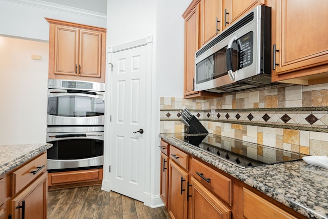 1005 Ruidoso Downs Dr, Talty, TX 75160 - kitchen with appliances with stainless steel finishes, light stone countertops, decorative backsplash, dark wood finished floors, and crown molding