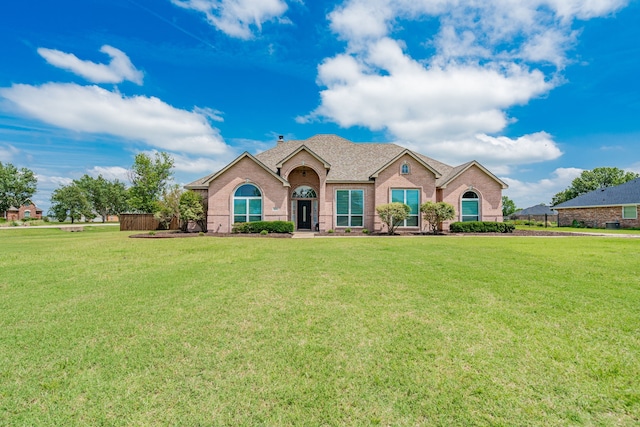 1005 Ruidoso Downs Dr, Talty, TX 75160 - ranch-style house with brick siding, a front lawn, and roof with shingles