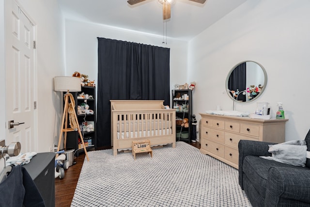 1005 Ruidoso Downs Dr, Talty, TX 75160 - bedroom featuring wood finished floors, a nursery area, and a ceiling fan