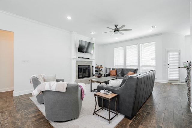 1005 Ruidoso Downs Dr, Talty, TX 75160 - living room featuring a ceiling fan, ornamental molding, a fireplace with raised hearth, recessed lighting, and wood finished floors