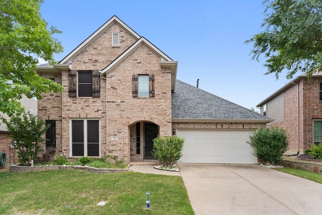 1908 Canyon Wren Dr, Mckinney, TX 75071 - view of front of home featuring an attached garage, a shingled roof, concrete driveway, brick siding, and a front yard