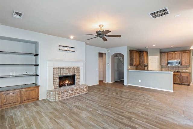 1908 Canyon Wren Dr, Mckinney, TX 75071 - unfurnished living room featuring ceiling fan, light wood-style flooring, a fireplace, recessed lighting, and baseboards