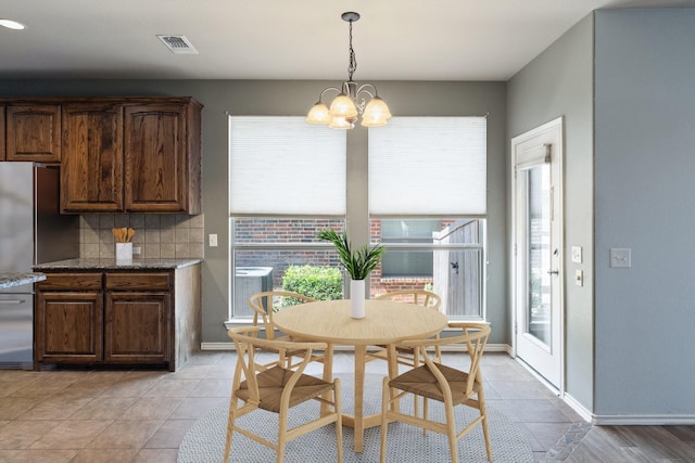1908 Canyon Wren Dr, Mckinney, TX 75071 - dining space featuring light tile patterned flooring, a chandelier, and baseboards