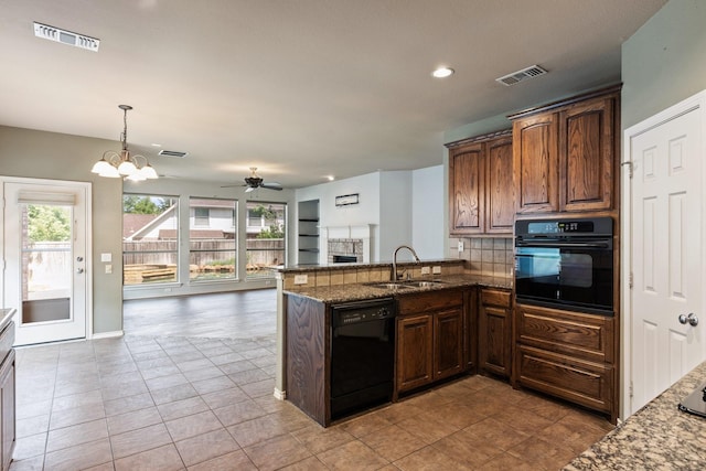 1908 Canyon Wren Dr, Mckinney, TX 75071 - kitchen with black appliances, a sink, dark stone countertops, open floor plan, and light tile patterned floors