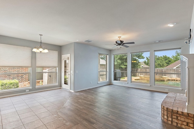 1908 Canyon Wren Dr, Mckinney, TX 75071 - unfurnished living room featuring a ceiling fan, wood finished floors, a chandelier, and baseboards