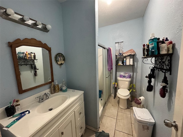 1206 Walnut St, Greenville, TX 75401 - full bathroom featuring a stall shower, vanity, tile patterned flooring, and a textured ceiling