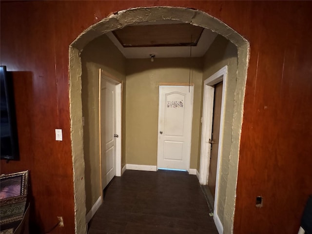 1206 Walnut St, Greenville, TX 75401 - hall with dark wood finished floors, attic access, and arched walkways