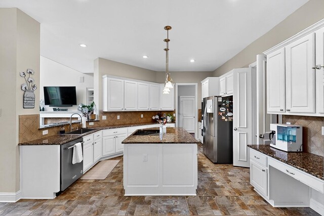 4700 Scoter Ln, Mckinney, TX 75072 - kitchen with stainless steel appliances, a center island, white cabinets, decorative backsplash, and recessed lighting