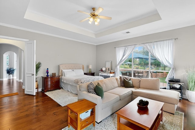 4700 Scoter Ln, Mckinney, TX 75072 - bedroom with a tray ceiling, arched walkways, wood finished floors, crown molding, and a ceiling fan