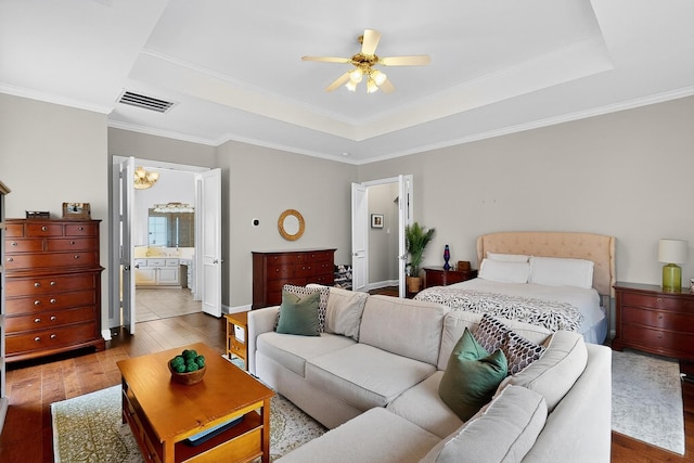 4700 Scoter Ln, Mckinney, TX 75072 - bedroom featuring a tray ceiling, wood-type flooring, crown molding, ensuite bathroom, and ceiling fan