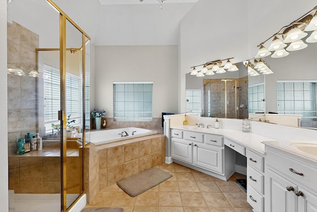 4700 Scoter Ln, Mckinney, TX 75072 - bathroom featuring tile patterned floors, double vanity, a shower stall, and a garden tub