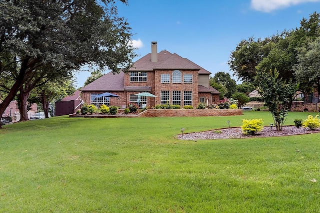 4700 Scoter Ln, Mckinney, TX 75072 - back of property with a chimney, brick siding, and a yard