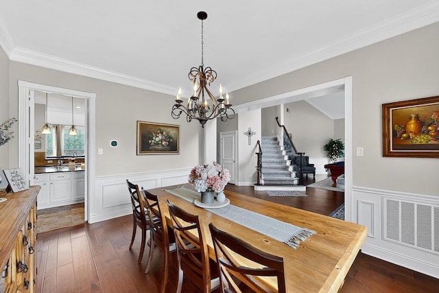 4700 Scoter Ln, Mckinney, TX 75072 - dining space with stairway, crown molding, a chandelier, wainscoting, and dark wood-style floors
