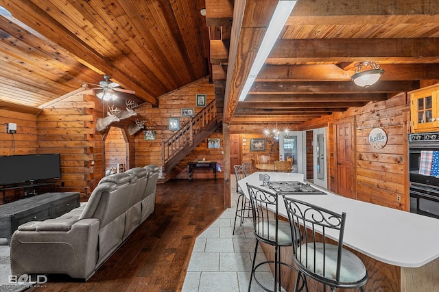 250 Mayo Rd, Shreveport, LA 71106 - living area with wood walls, wood ceiling, stairway, a ceiling fan, and dark wood-style floors