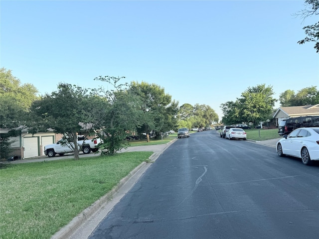 1136 Simpson Dr, Hurst, TX 76053 - view of asphalt road featuring curbs