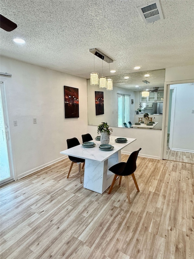 1136 Simpson Dr, Hurst, TX 76053 - dining area with a textured ceiling, light wood finished floors, ceiling fan, and recessed lighting