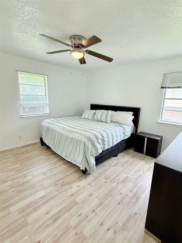 1136 Simpson Dr, Hurst, TX 76053 - bedroom with a textured ceiling, light wood-type flooring, and ceiling fan