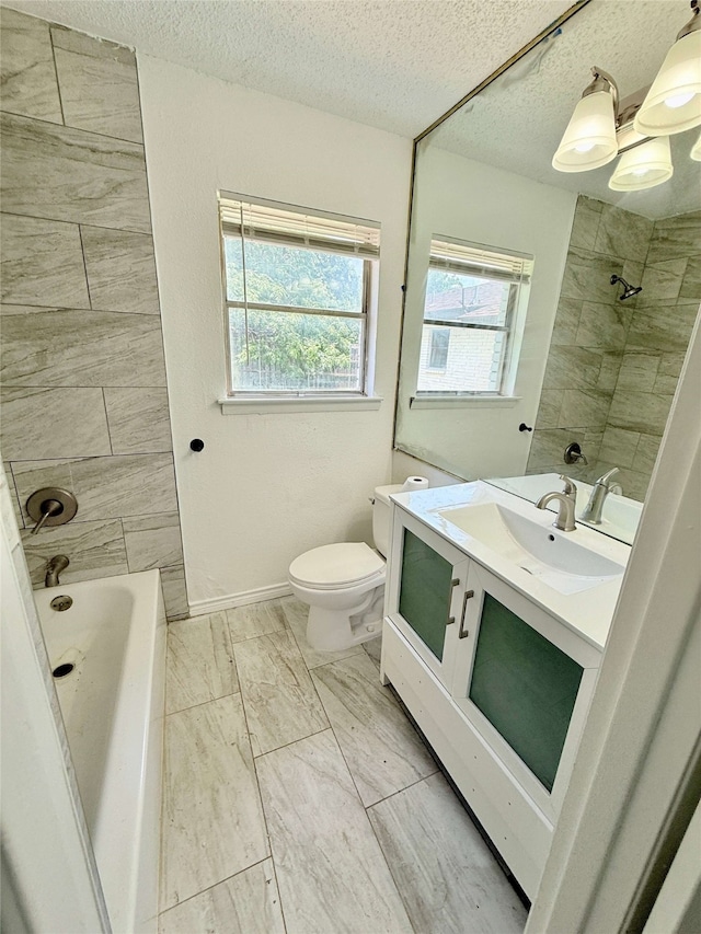 1136 Simpson Dr, Hurst, TX 76053 - full bath with a textured ceiling, vanity, marble finish flooring, and bathtub / shower combination