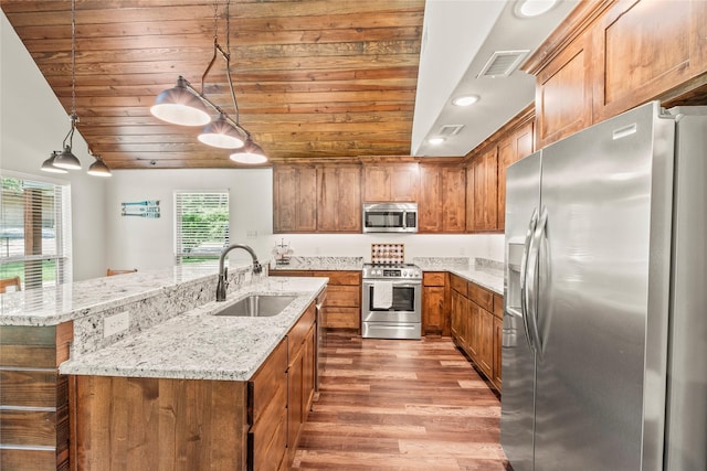 102 Anderson Ln, Mabank, TX 75156 - kitchen featuring stainless steel appliances, a sink, wood ceiling, brown cabinets, and wood finished floors