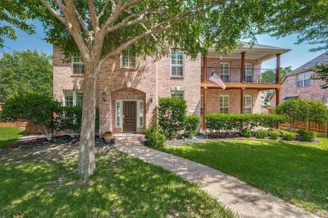 2673 April Sound Ln, Frisco, TX 75033 - view of front facade featuring brick siding, a front yard, and a balcony