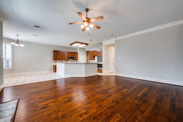 2673 April Sound Ln, Frisco, TX 75033 - unfurnished living room with light wood-style floors, a ceiling fan, baseboards, a chandelier, and crown molding