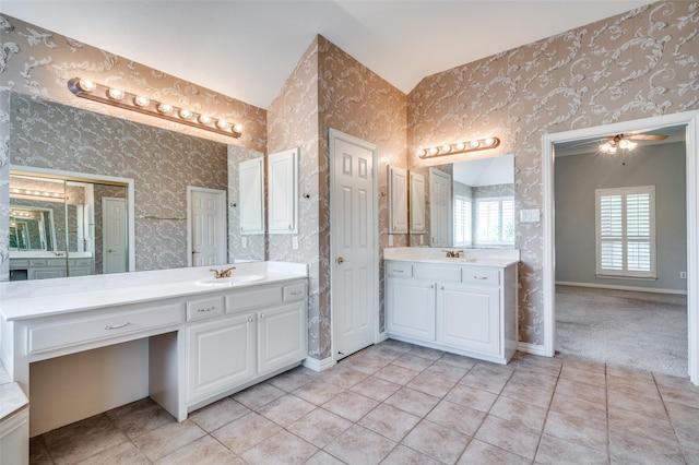 2673 April Sound Ln, Frisco, TX 75033 - full bathroom with two vanities, wallpapered walls, tile patterned flooring, and baseboards