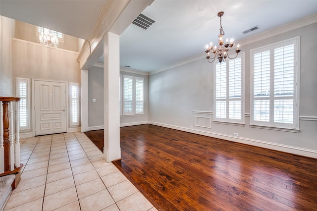 2673 April Sound Ln, Frisco, TX 75033 - foyer entrance featuring a chandelier, crown molding, plenty of natural light, hardwood / wood-style flooring, and baseboards