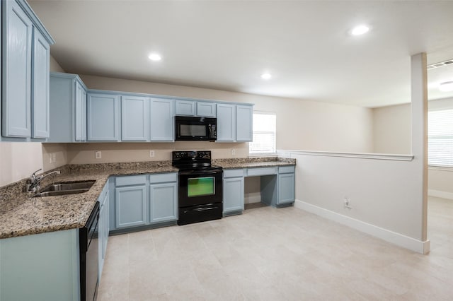 10556 Midway Dr, Frisco, TX 75035 - kitchen with black appliances, a sink, light stone countertops, recessed lighting, and baseboards