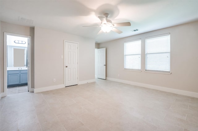 10556 Midway Dr, Frisco, TX 75035 - unfurnished bedroom with baseboards, connected bathroom, and a ceiling fan