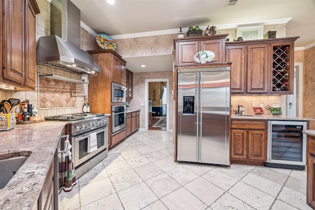 3820 Nash Ln, Plano, TX 75025 - kitchen with built in appliances, beverage cooler, wall chimney range hood, crown molding, and light stone countertops