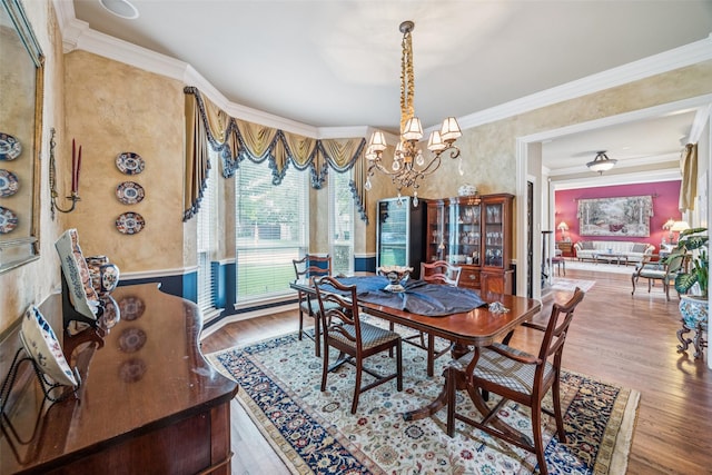 3820 Nash Ln, Plano, TX 75025 - dining space with wood finished floors, a chandelier, ornamental molding, and wallpapered walls
