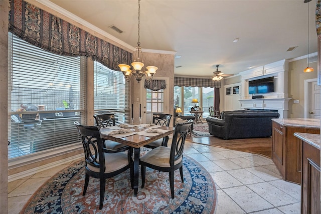 3820 Nash Ln, Plano, TX 75025 - dining area with a chandelier, ornamental molding, ceiling fan, and a fireplace