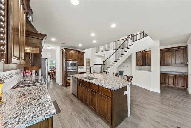 3300 Calvin Rd, Mckinney, TX 75071 - kitchen with appliances with stainless steel finishes, a sink, light wood-type flooring, baseboards, and recessed lighting