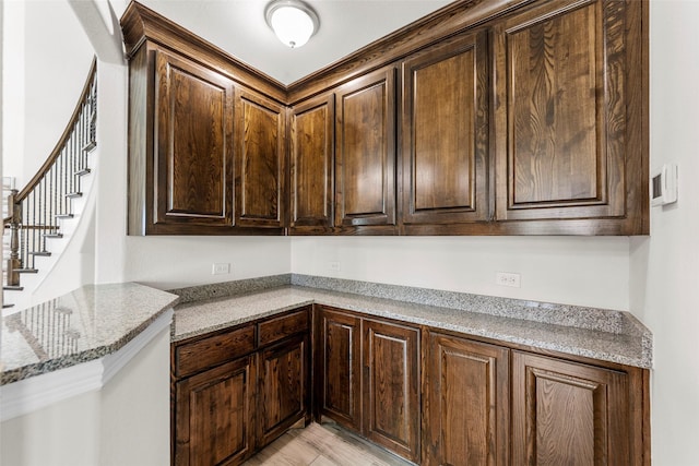 3300 Calvin Rd, Mckinney, TX 75071 - kitchen featuring dark brown cabinetry, light stone counters, and light wood-style flooring